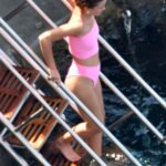 EMMA WATSON shows off her body in a pink bikini at the beach in Italy