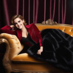 Emma Watson’s Timeless Elegance: Graceful Posing in an Evening Gown on the Sofa