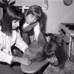 Teenage Girls Iron Their Hair Before a Night Out in New York City, 1964 _ US